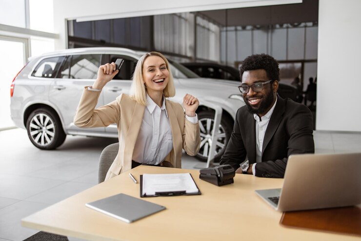 Photo une jeune femme blanche heureuse assise à table et reçoit les clés d'une voiture suv