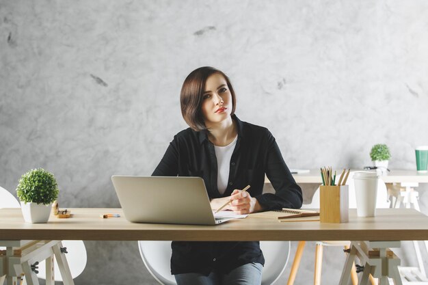 Jeune femme blanche travaillant sur un projet