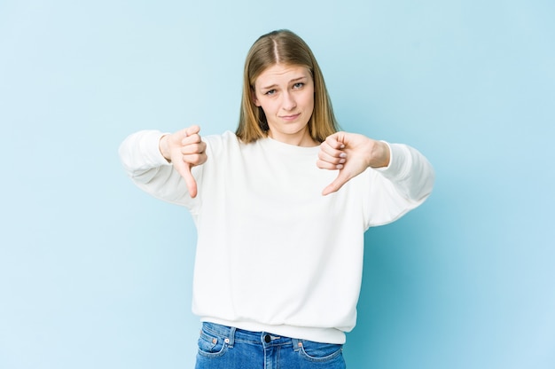 Jeune femme blonde montrant les pouces vers le bas