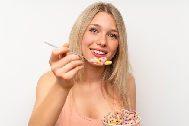 Jeune femme blonde prenant son petit déjeuner