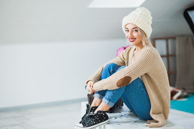 Jeune femme en bonnet tricoté main chaude à la maison