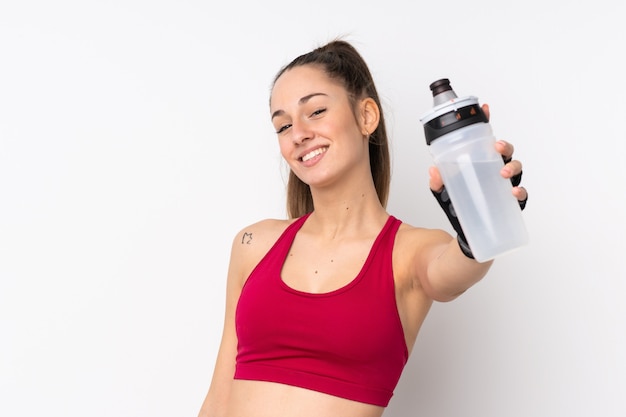 Jeune femme brune sport sur mur blanc isolé avec bouteille d'eau de sport
