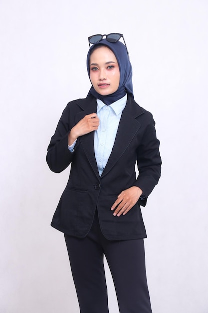 jeune femme de bureau asiatique en chemise bleue hijab debout à la caméra élégamment mains sur veste et po