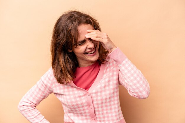 Jeune femme caucasienne isolée sur fond beige joyeux rire beaucoup concept de bonheur