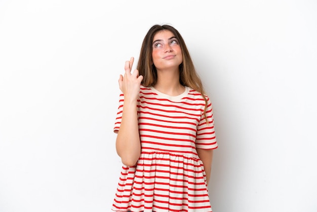 Photo une jeune femme caucasienne isolée sur un fond blanc avec les doigts croisés et souhaitant le meilleur