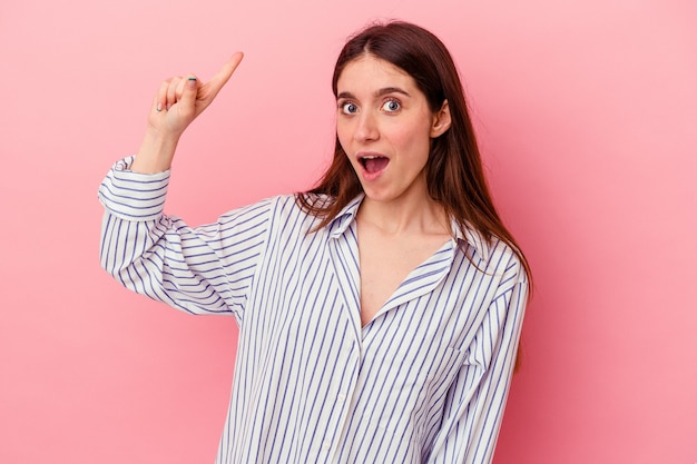 Jeune femme caucasienne isolée sur fond rose ayant une bonne idée, concept de créativité.