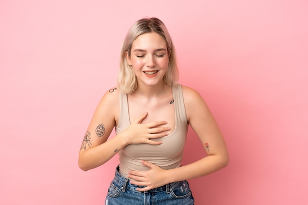 Jeune femme caucasienne isolée sur fond rose souriant beaucoup