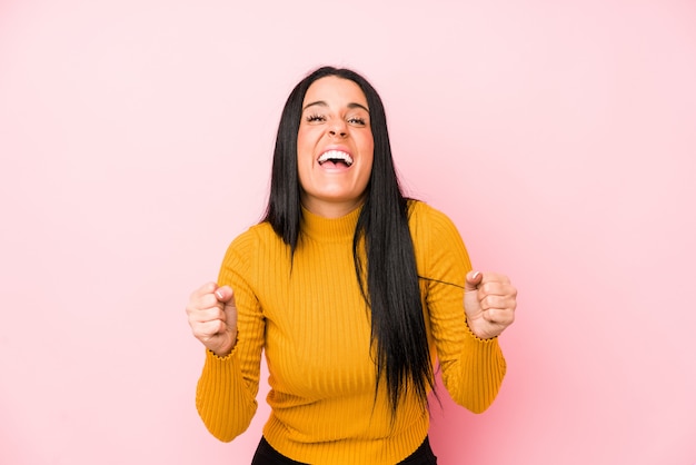 Jeune femme caucasienne isolée sur rose applaudissant sans soucis et excité. Concept de victoire.