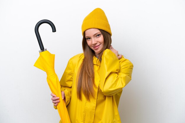 Jeune femme caucasienne avec manteau imperméable et parapluie isolé sur fond blanc en riant