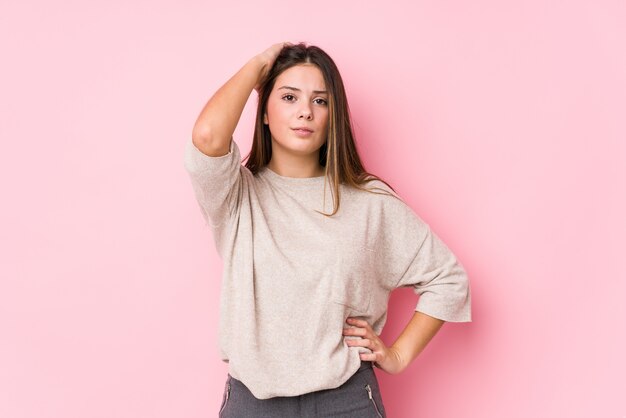 Jeune femme caucasienne posant isolé fatigué et très endormi en gardant la main sur la tête.