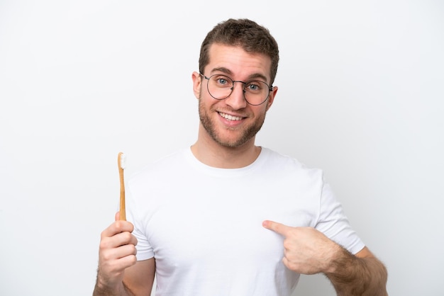 Jeune femme caucasienne se brosser les dents isolé sur fond blanc avec une expression faciale surprise