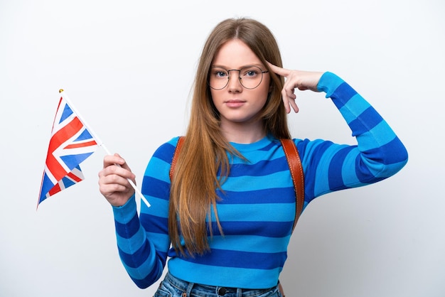 Jeune femme caucasienne tenant un drapeau du Royaume-Uni isolé sur fond blanc