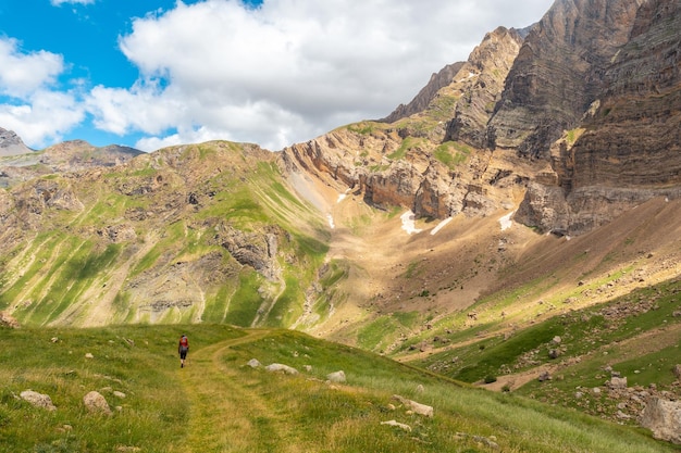 Une jeune femme dans le trekking en montagne avec son fils dans le sac à dos dans les Pyrénées de la vallée de Ripera