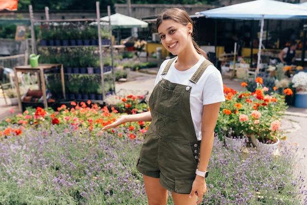 Jeune femme debout devant un comptoir avec des fleurs