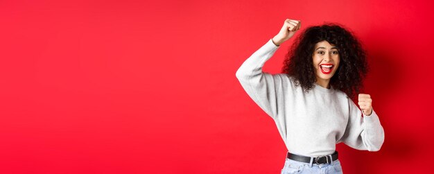 Photo une jeune femme debout sur un fond jaune