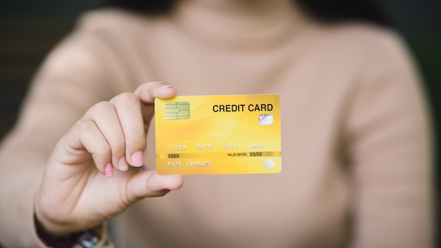 Jeune femme détenant une carte de crédit