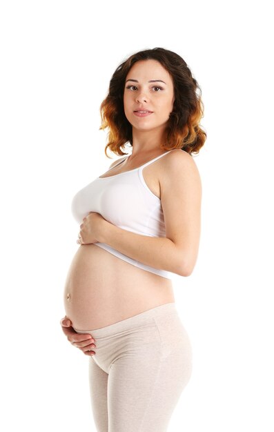 Jeune femme enceinte heureuse sur blanc