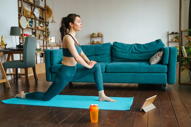 La jeune femme est engagée dans la remise en forme à la maison