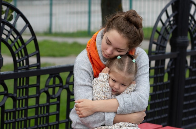 Jeune femme étreignant un enfant avec amour et tendresse