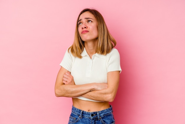 Jeune femme expressive posant sur fond rose