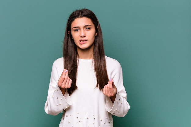 Jeune femme indienne isolée sur un mur bleu montrant qu'elle n'a pas d'argent.