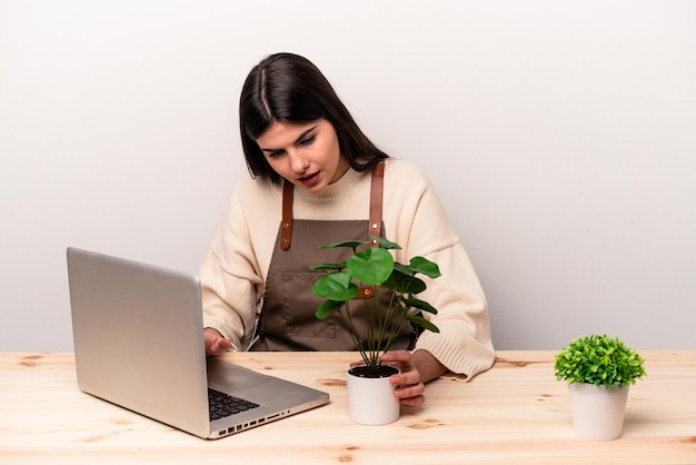 Jeune femme jardinier caucasien travaillant sur la table isolé sur fond blanc