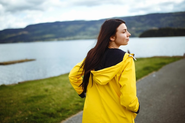 La jeune femme jouit de la liberté sur fond de montagnes en Norvège La fille touriste