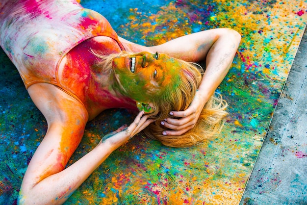 Jeune femme joyeuse au festival de peinture holi