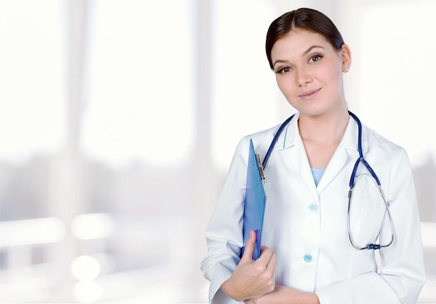 Jeune femme médecin avec stéthoscope tient un ordinateur portable