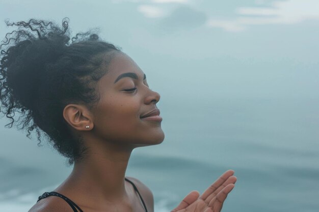 Une jeune femme noire souriante lève les yeux vers le ciel