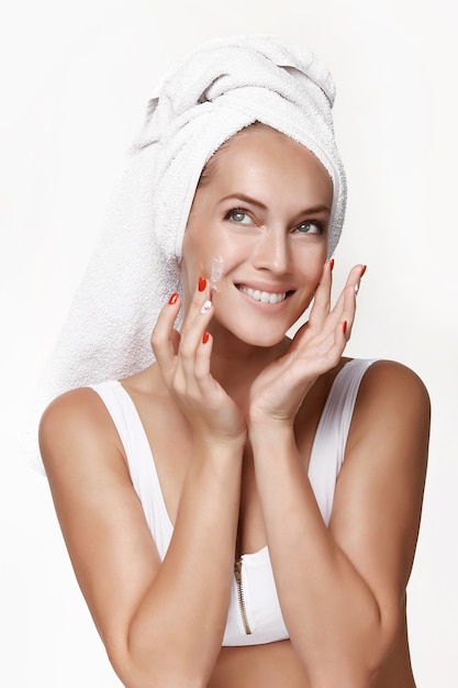 Jeune femme avec une peau parfaite, appliquer la crème