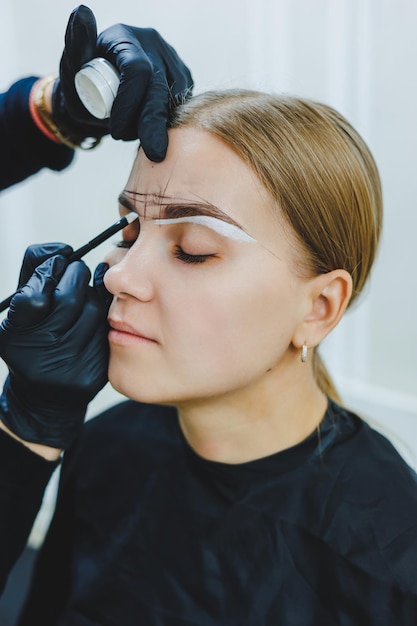 Jeune femme pendant la procédure de cartographie professionnelle des sourcils avant le maquillage permanent