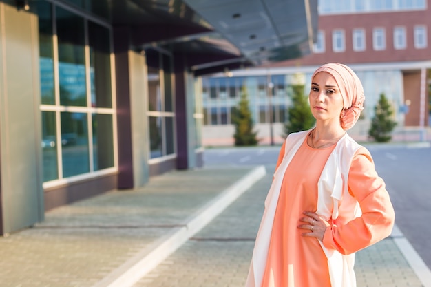 Jeune femme portant un foulard hijab en ville.