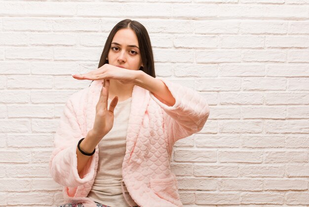 Jeune femme, porter, pyjama, faire, a, délai d'attente, geste