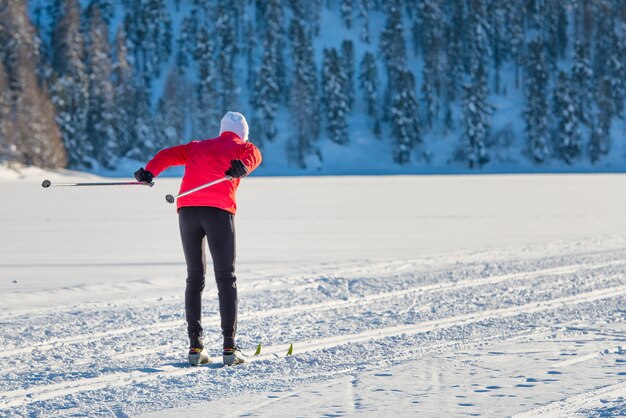 Jeune femme pratiquant le ski sur la montagne