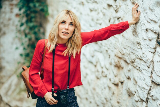 Jeune femme prenant des photos avec un vieil appareil photo dans une belle ville.