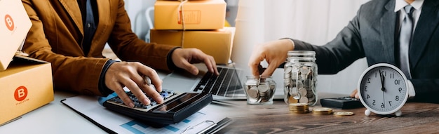 Jeune femme propriétaire d'une petite entreprise faisant des achats en ligne à la maison en prenant note des commandes des clients avec des téléphones mobiles PME entrepreneur ou concept de style de vie indépendant