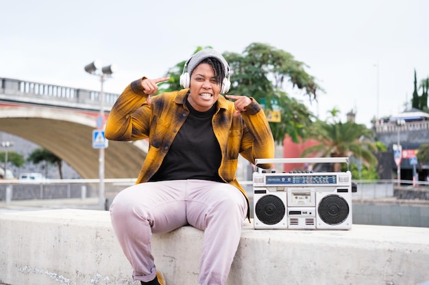 Jeune femme rap dans la rue à côté de son vintage boom box Concept freestyle lifestyle music