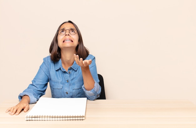 Jeune femme à la recherche désespérée et frustrée, stressée, malheureuse et agacée, criant et criant