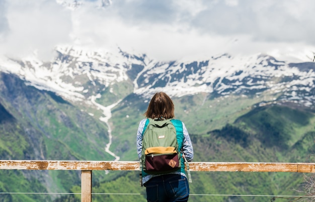 Jeune femme regarde un beau paysage de montagne