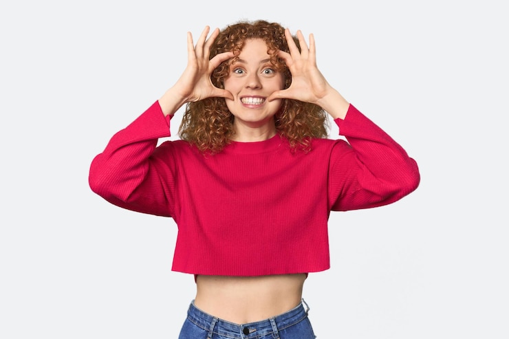 Photo une jeune femme rousse blanche qui garde les yeux ouverts pour trouver une opportunité de succès.