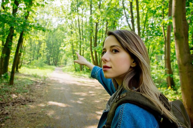 Jeune femme avec sac à dos dans une forêt mixte Beskidy en Pologne au printemps.