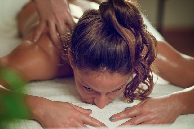 Photo une jeune femme se détend et fait un massage relaxant des épaules et du cou dans un salon de spa.