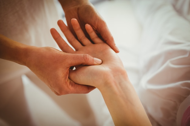 Jeune femme se massage des mains