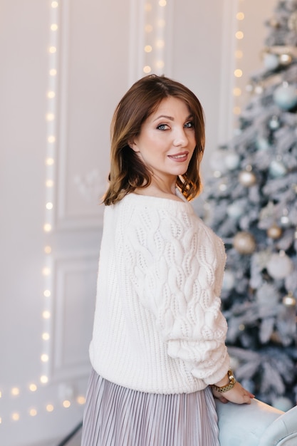 Une jeune femme séduisante dans un pull blanc