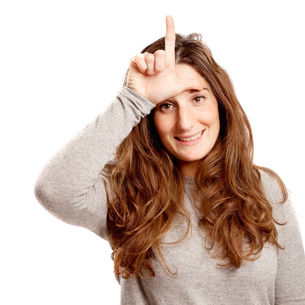 Jeune femme sinueuse geste de perdant sur blanc