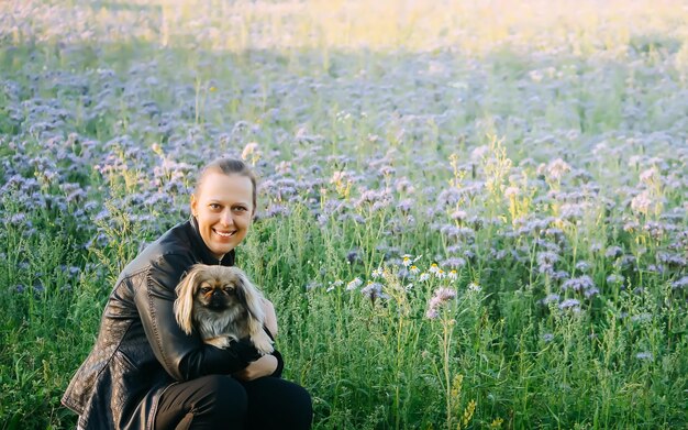 Jeune femme avec son chien mignon à l'extérieur