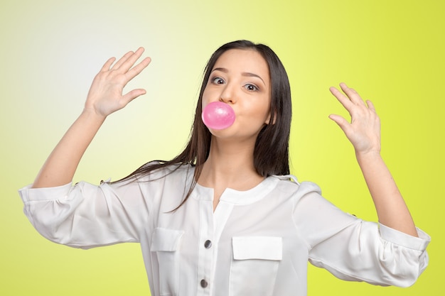 Jeune femme soufflant du chewing-gum