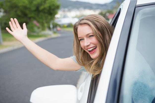 Jeune femme souriante et agitant