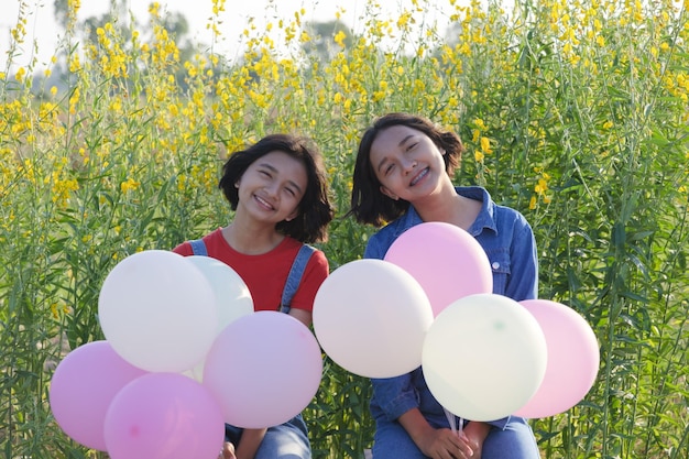 Photo une jeune femme souriante avec des ballons contre des plantes